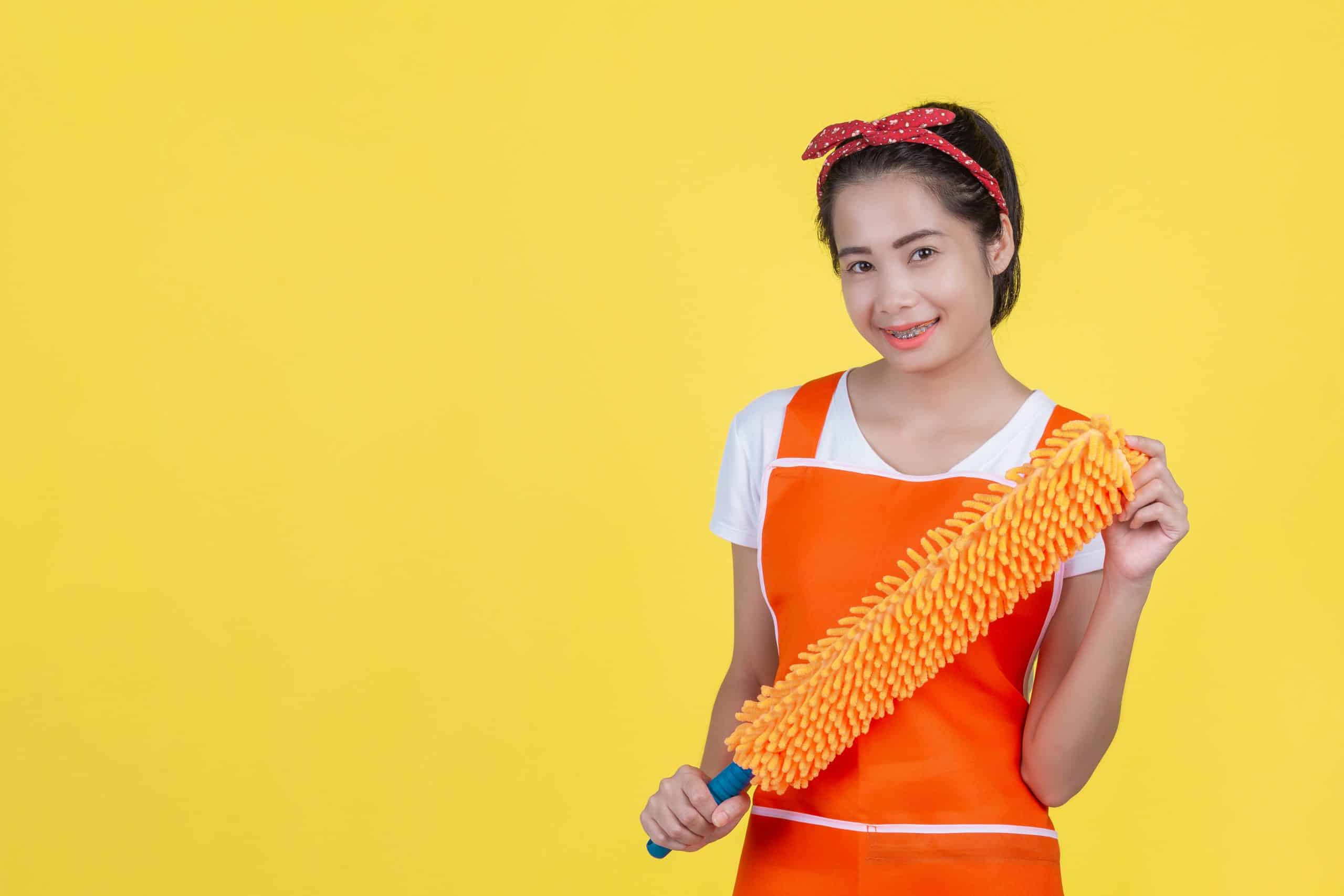 indonesian helper holding an orange window wiper